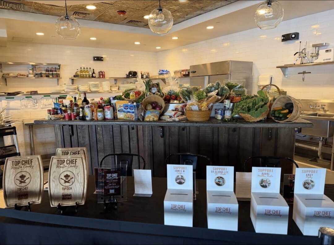 Top Chef Martin County 2026 awards table with wooden plaques and ingredient baskets
