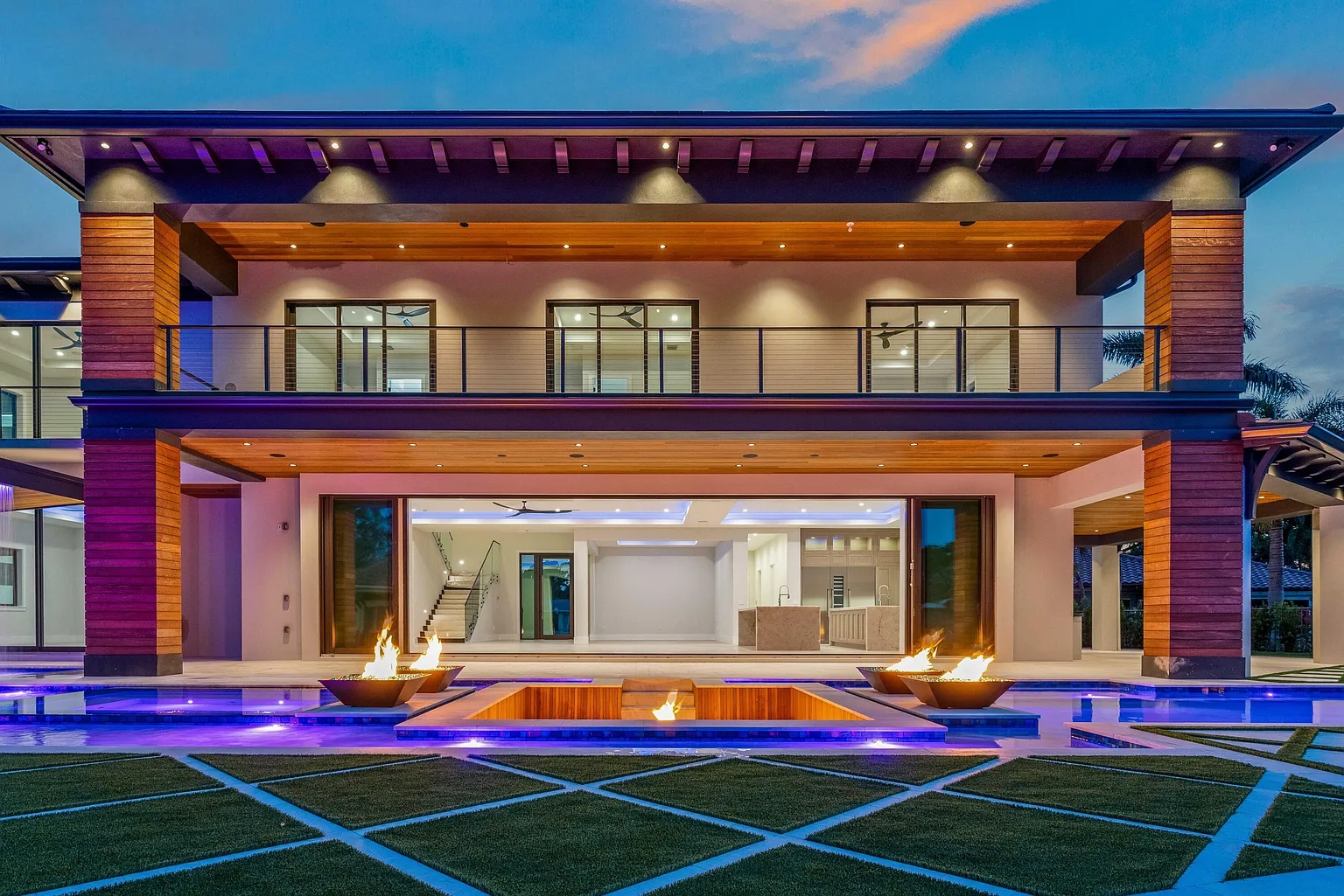 Luxury Florida glass installation — floor-to-ceiling impact windows and sliding doors at twilight
