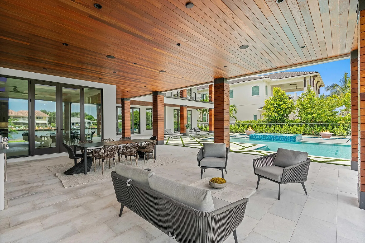 1172 S Harbor covered patio with ES Prestige glass doors opening to waterway