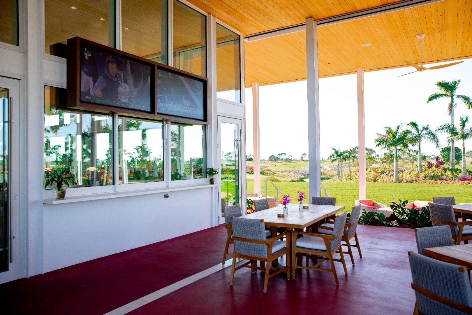 Interior lounge with slab-to-slab glass wall open to the golf course