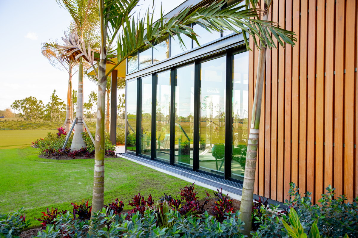 Atlantic Fields Performance Center - dark framed window wall meeting the cedar fins