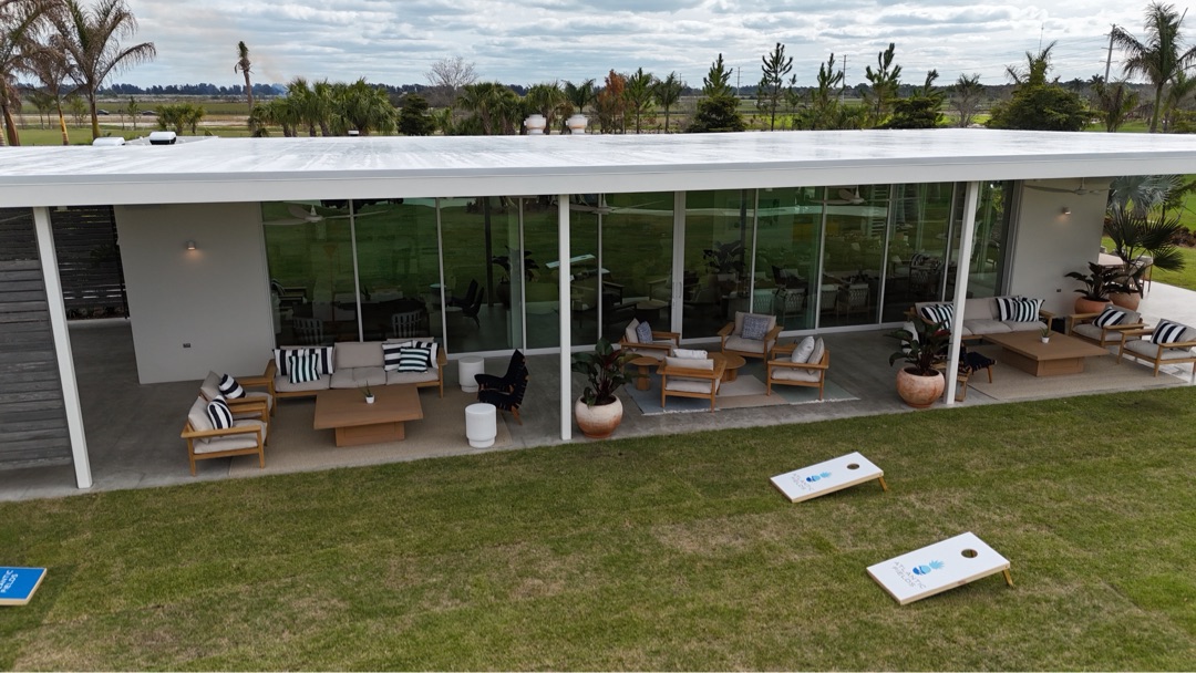 Atlantic Fields Sales Center — glass pavilion at dusk