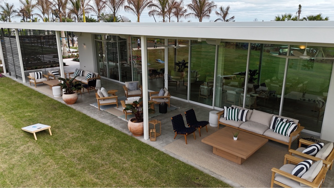 Atlantic Fields Sales Center long elevation — pocketing multi-slide doors and covered patio with palm shade