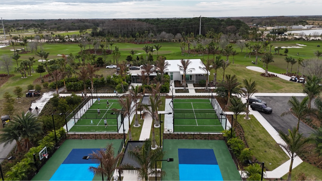 Aerial view &mdash; the Sales Center sits at the head of the racquet club with padel and pickleball courts in front