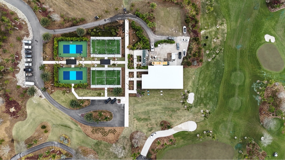 Top-down site overhead showing the Sales Center's relationship to the courts and the Tom Fazio fairway beyond