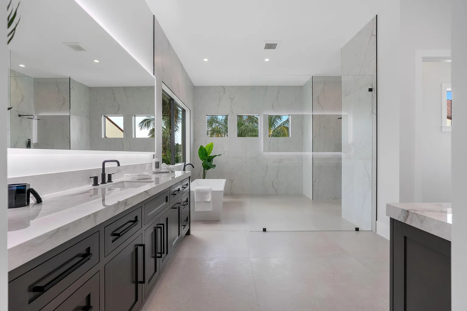 Master bathroom with ES Prestige impact windows and frameless glass shower