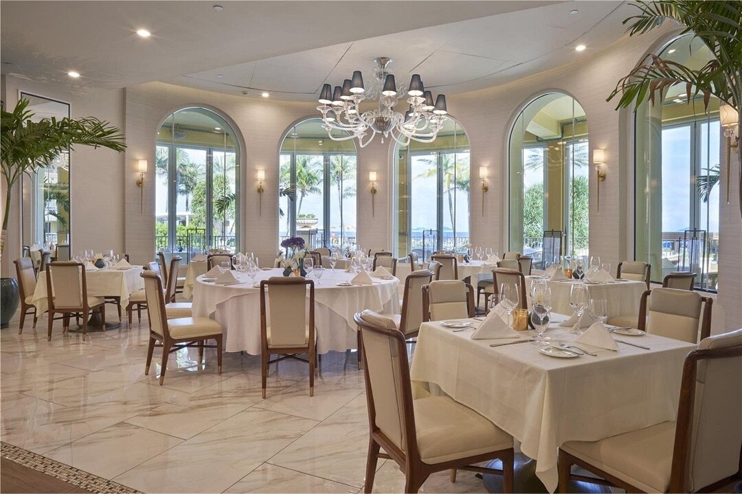 Polpo restaurant interior — arched glass windows, chandeliers, white linens, Atlantic view
