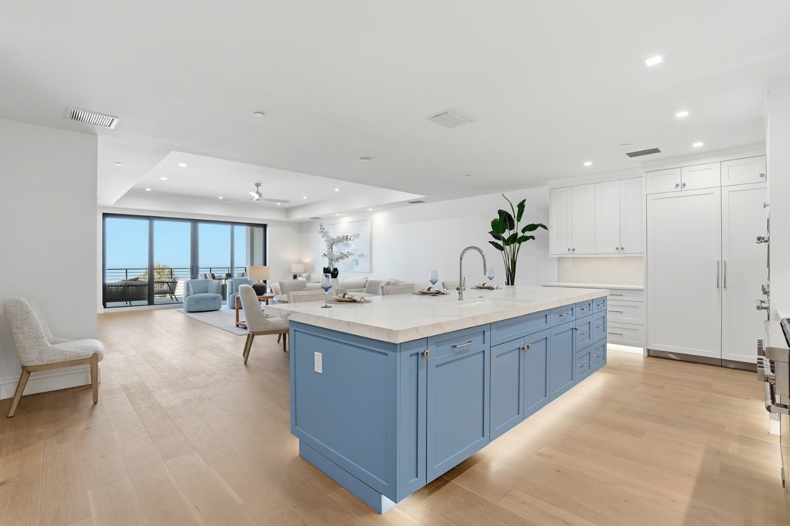 Open-concept kitchen with Gulf view through full-height impact glazing
