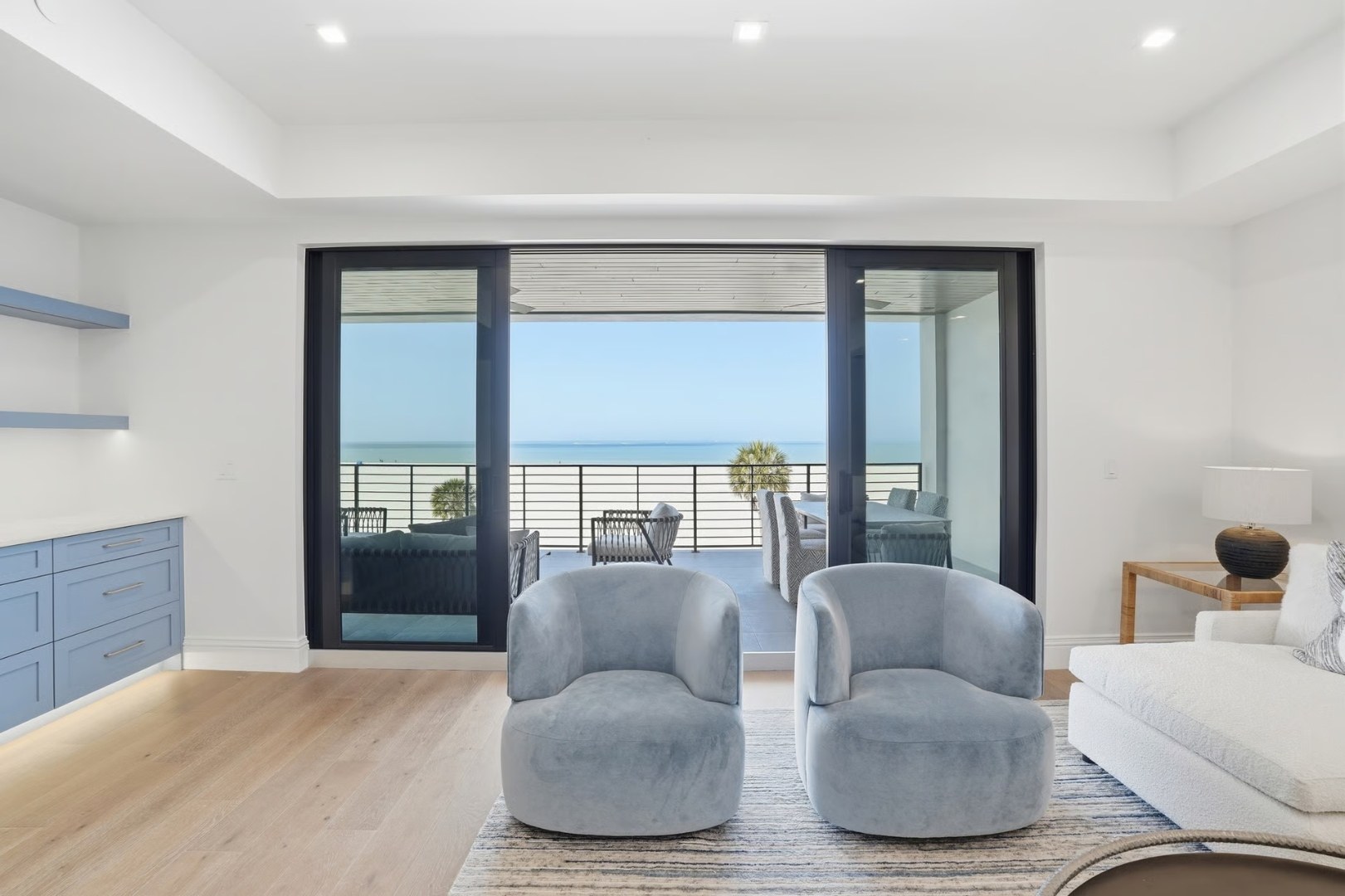 Gulfside Twelve living room — full-height impact sliding glass doors