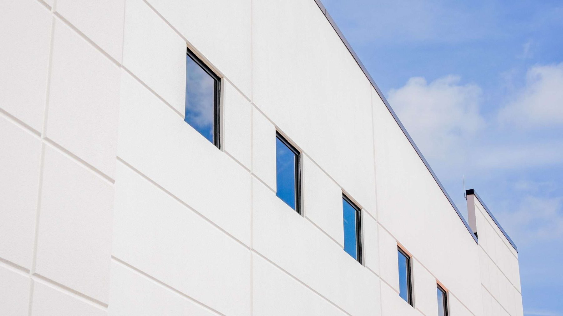 Punched storefront openings in the tilt-wall concrete facade
