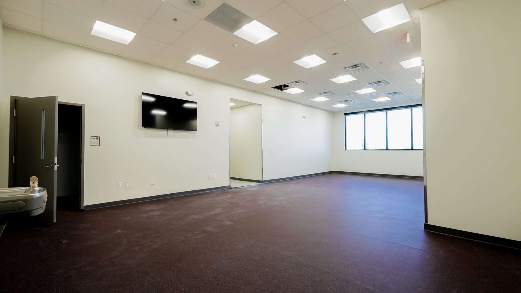 Training and EOC operations room interior with daylight from impact-rated storefront windows