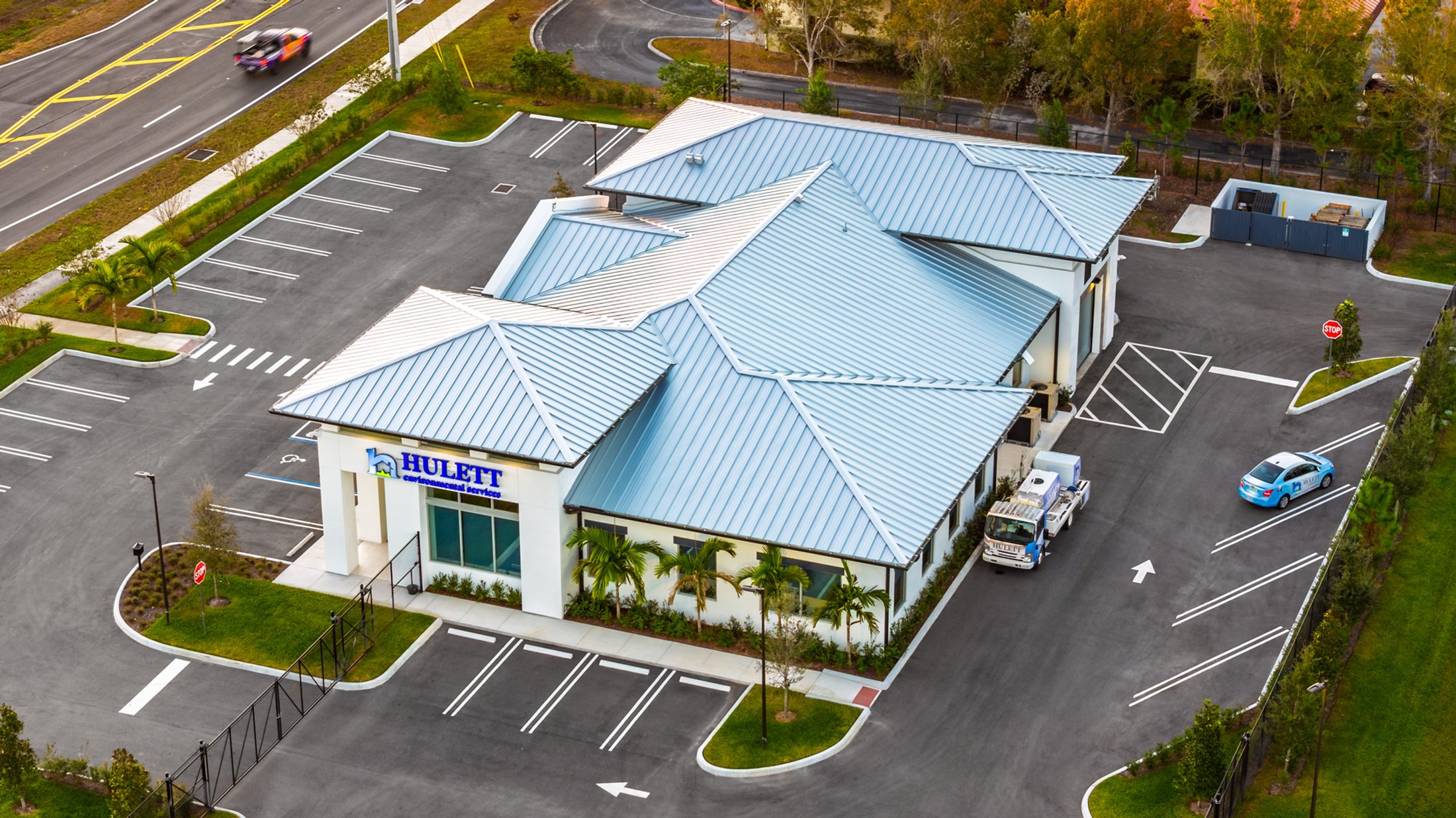 Hulett Environmental aerial — rear elevation in daylight, showing the back-of-house side and additional landscaping