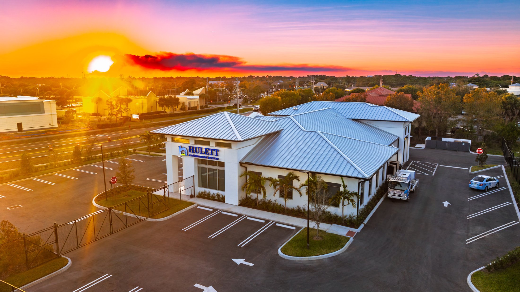 Hulett Environmental Services headquarters at sunset — Port St. Lucie FL, ESWindows commercial storefront and window package, Hooks Construction GC