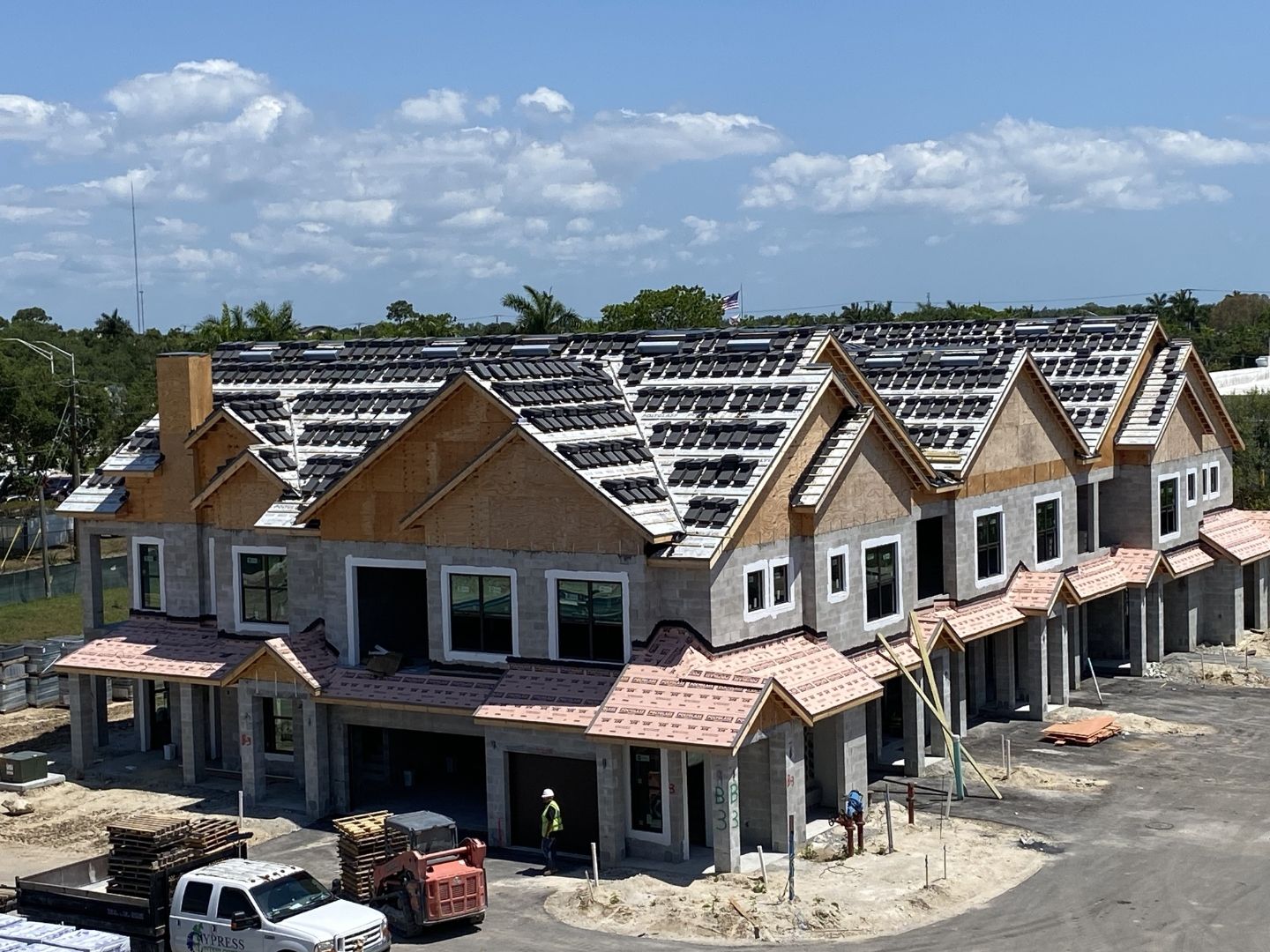 Aerial view of Imperial Crossings townhome buildings during construction Bonita Springs FL — PGT impact windows being installed across multiple units by American Commercial Glass
