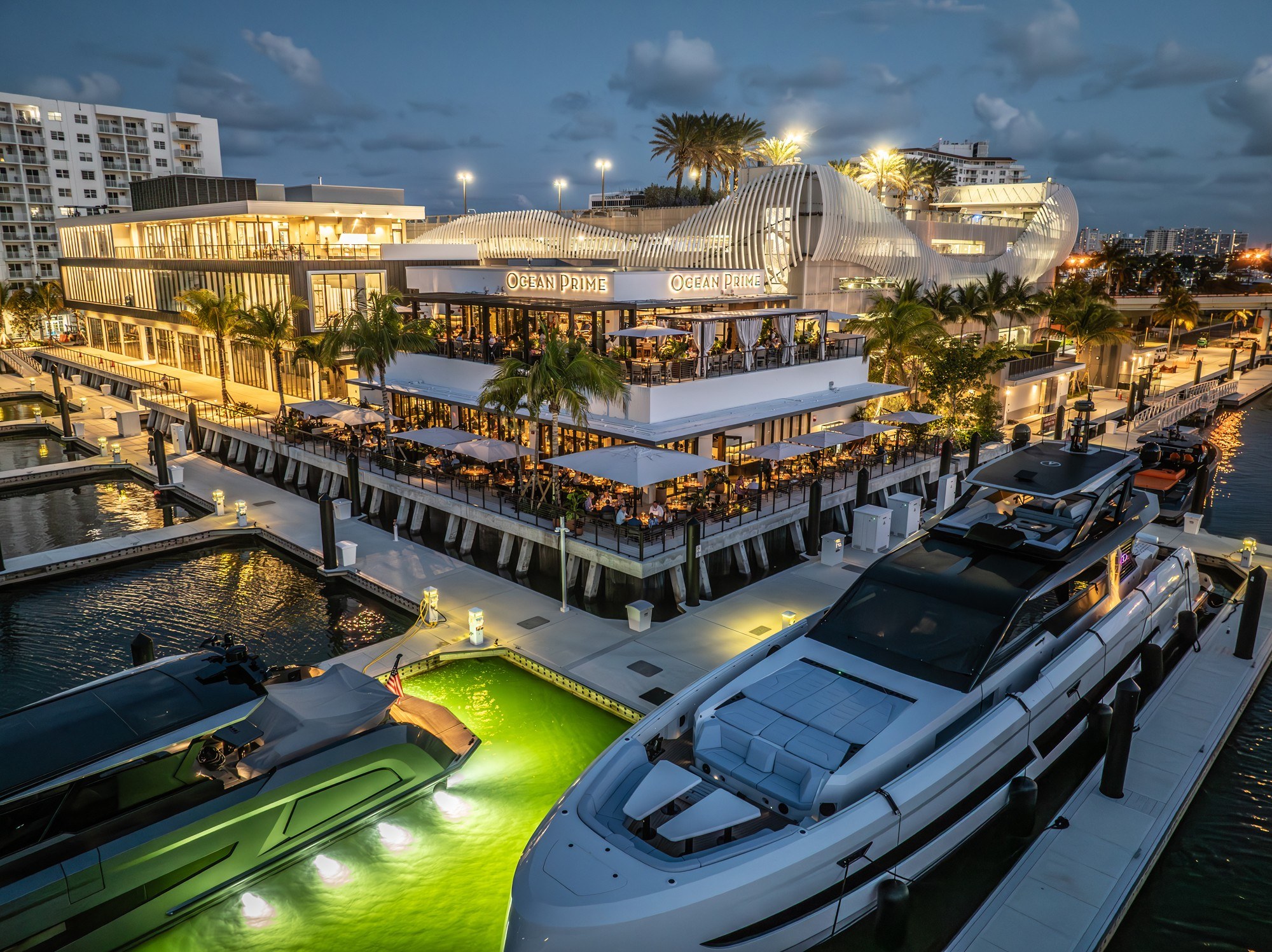 Ocean Prime Fort Lauderdale — marina aerial at twilight with superyachts and Euro-Wall folding glazing by American Commercial Glass