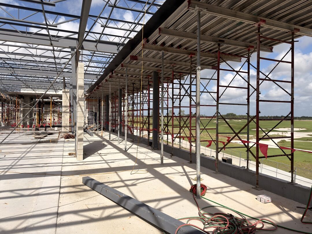 Panther National Clubhouse — interior steel framing looking out to golf course, glazing openings ready for Eurowall systems