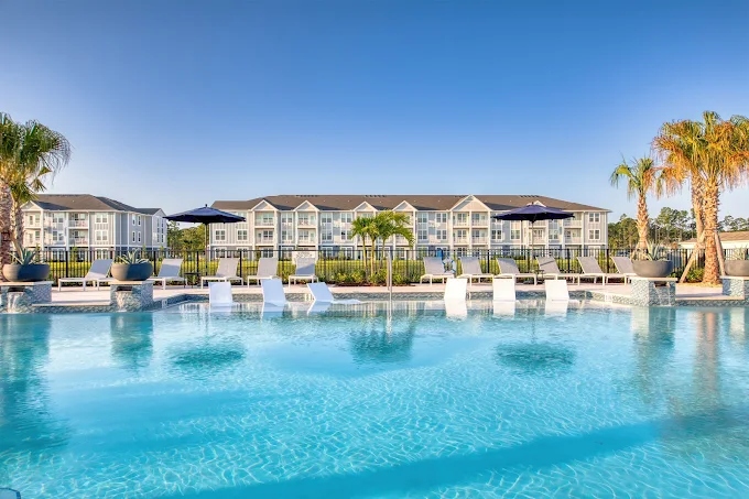 The Pointe at Palm Bay pool with apartment buildings behind