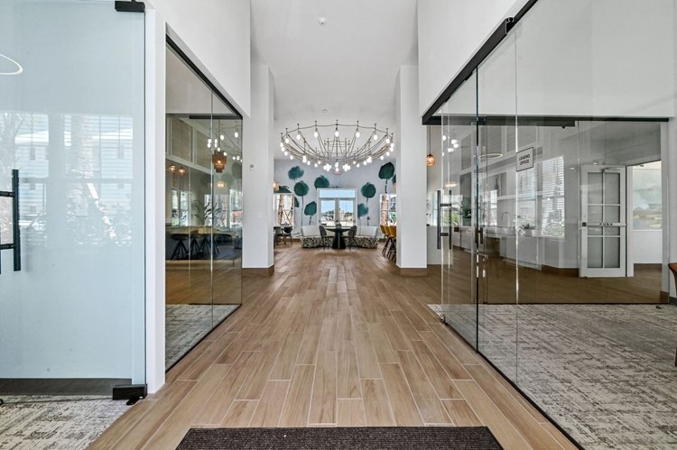 Tradewinds Hobe Sound clubhouse interior entry with frameless all-glass storefront doors and sidelites