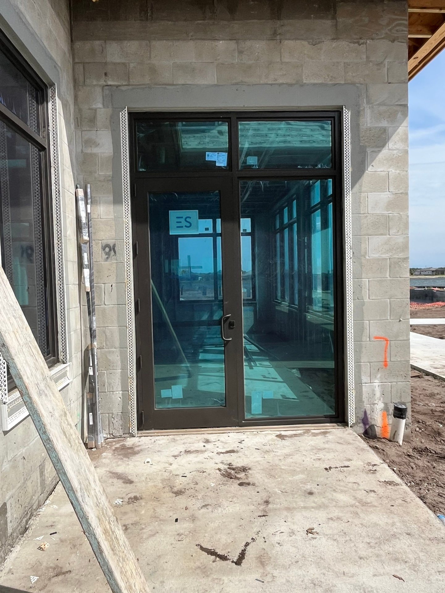 Wild Blue Clubhouse feature entry doors at the porte-cochère