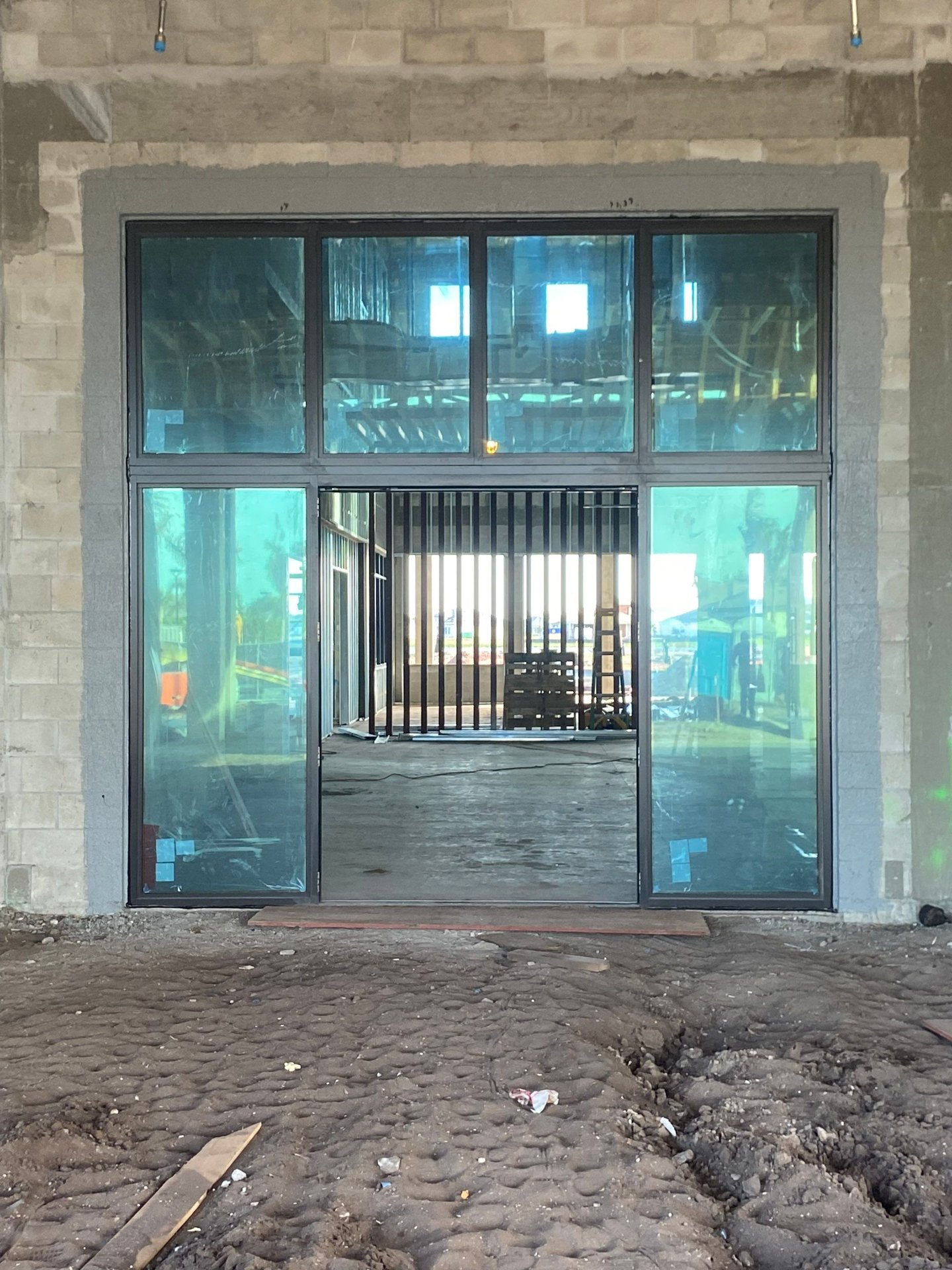 Wild Blue Clubhouse — main storefront wall glazing installation, March 2026