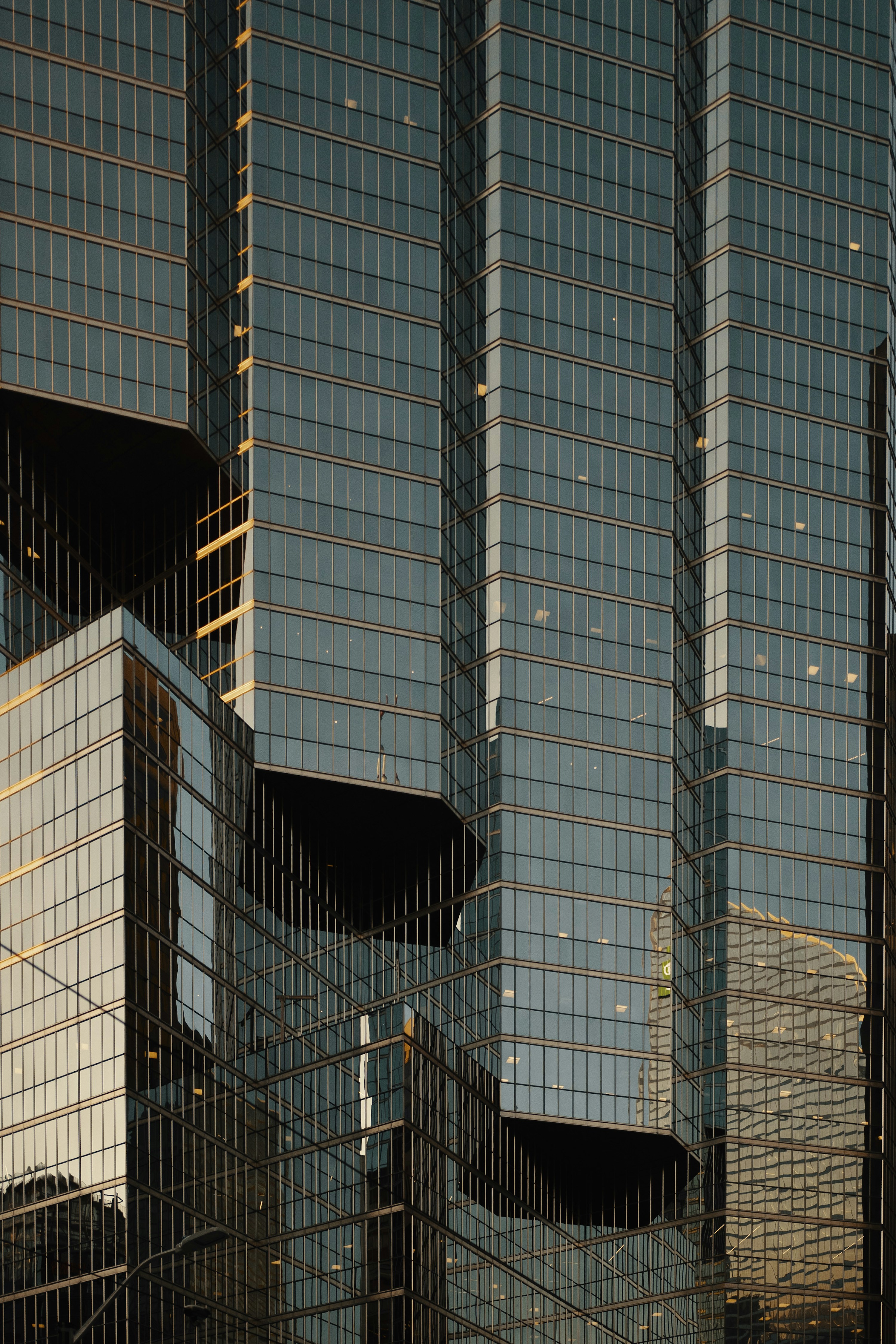 Modern glass skyscraper at sunset